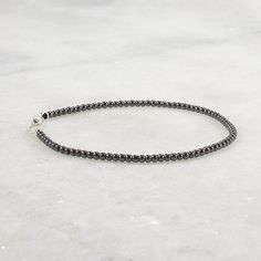 This delicate hematite bracelet is accented with sterling silver beads. The beads are tiny 2mm hematite beads. The clasp is a secure lobster claw. This minimalist bracelet can be worn alone or layered with your other gemstone bracelets. This dainty bracelet is made of 2mm beads, see pictures to see the scale of the beads. Ultra Skinny Bracelet 2mm round hematite beads lobster claw clasp and oversized ring for easy clasping strung on cord for durability and a soft drape Choose your bracelet lengt Minimalist Single Strand Beaded Bracelets, Minimalist Silver Beaded Bracelet With Black Beads, Minimalist Hematite Round Bead Jewelry, Silver Hematite Beaded Bracelets With Black Beads, Elegant Hematite Beaded Bracelets With Silver Beads, Silver Minimalist Hematite Jewelry, Minimalist Silver Hematite Jewelry, Gift Bracelet With Silver Beads And Hematite, Oversized Ring