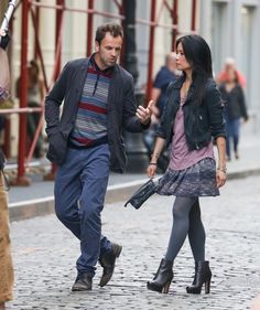 a man and woman walking down the street