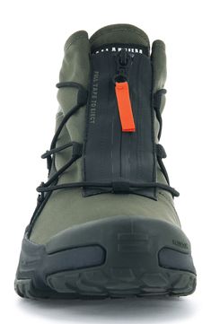 the side view of a pair of hiking shoes with an orange tag attached to it