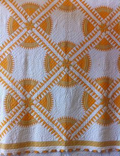 an orange and white quilt with circles on it