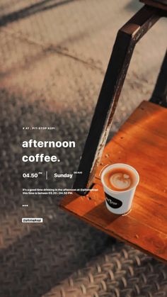 a cup of coffee sitting on top of a wooden table