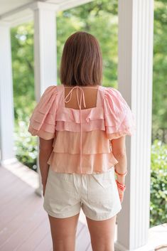 Mauve and pink colorblock ruffle layer tiered top with puff sleeves Ruffed Sass is this Summer's prettiest little top! Mauve and pink colorblock fabric in ruffle layered tiers, featuring a square neckline and ruffle layer tiered puff sleeves. Perfect for any upcoming occasion, this babe will make you stand out in style! Dress her up with a skirt and heels, or wear her casually in a boho style with shorts or jeans, and sandals (or barefoot at the beach). True to size fit; relaxed silhouette Model Purple Ruffle Sleeve Spring Top, Cruise Vacation Outfits, Summer Ruffle T-shirt With Flutter Sleeves, Top With Puff Sleeves, Summer Ruffle Flutter Sleeve T-shirt, Pink Ruffle Sleeve T-shirt With Ruffles, Ruffled Tops, Cotton Ruffle T-shirt With Flutter Sleeves, Colorblock Top