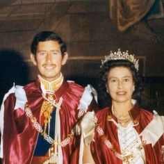 a man and woman dressed up in regal dress posing for a photo with each other