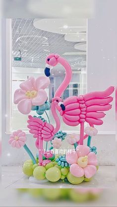 a pink flamingo sculpture sitting on top of a table