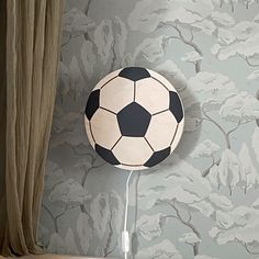 a black and white soccer ball hanging on the wall