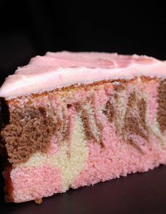 a piece of cake with pink frosting on it