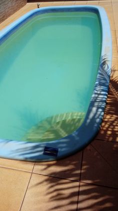 an empty swimming pool is shown in the shade