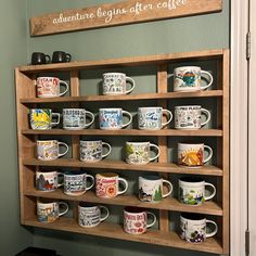 coffee mugs are lined up on a shelf