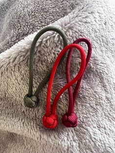 a red leash laying on top of a white blanket