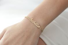 "14k Solid Gold Name Plate Bracelet/Personalized Name Bracelet/Gold Name Bracelet/Handmade Name Bracelet With Curb Chain Perfect gift for birthday, anniversary, christmas, bridesmaid, graduation, wedding, engagement, best friend, mom and sisters. ---> All of our products are made of high quality of 14k Gold. It is not gold plated or filled ---> Please add your name in personalization box Item Specification --> Material: 14k Solid Gold --> Charm Size: 30x7mm --> Charm Thickness: 0.6mm --> Curb Wi Dainty Yellow Gold Name Bracelets, Dainty Yellow Gold Bracelets With Name, 14k Gold Name Bracelet Jewelry, Personalized 14k Gold Bracelet, Elegant Handmade Gold Name Bracelet, Elegant Yellow Gold Name Chain Bracelet, Elegant Name Chain Bracelet, Elegant Handmade Name Bangle Bracelet, Handmade 14k Gold Bracelet As Gift