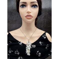 Explore the delicate allure of nature with our Beaded Lily of the Valley Cluster Necklace. Crafted from shimmering white beads, each intricately woven blossom evokes the charm of the beloved flower. Adorned with pristine glass leaves and translucent bicone accents, this necklace exudes timeless elegance. Perfect for adding a touch of ethereal beauty to any ensemble, it's a graceful ode to floral enchantment Height of beaded pendant : 3 3/4 inches ( 9.5 cm ) Length of chain : 22 inches ( 56 cm ) Adjustable White Jewelry With Flower Decoration, White Pearl Pendant Jewelry, Elegant Beaded Necklace With Flower Pendant, Elegant Beaded Flower Pendant Necklace, Silver Beaded Flower Pendant Necklace, Beaded Flower-shaped Pearl Necklace, Elegant White Crystal Necklaces With Pearl Drop, Elegant White Crystal Necklace With Pearl Drop, White Beaded Necklaces With Pearl Pendant