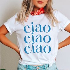 Ciao T-shirt paired with your favorite jeans and cardigan and your suddenly an effortlessly chic European fashion goddess. Select your size and your favorite color option and we'll have it produced and delivered in about a week. Exclusively designed by Parcel 23 and printed in the USA Classic unisex super soft cotton blend tee This shirt is printed on everybody's favorite, Bella + Canvas unisex jersey tee. If you don't have one of these shirts, you're in for a treat. Sustainably sourced, 100% co Chic Summer T-shirt With Letter Print, Trendy Everyday Shirt With Letter Print, Casual Tops With Funny Text For Spring, Trendy Blue Top With Funny Text, Trendy Crew Neck Shirt For Day Out, Chic Cotton T-shirt For Everyday, Trendy Slogan Tops For Day Out, Spring Casual T-shirt With Funny Text, Trendy Letter Print T-shirt For Day Out