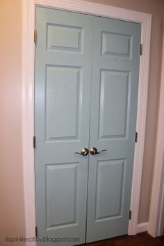 two blue double doors in the corner of a room