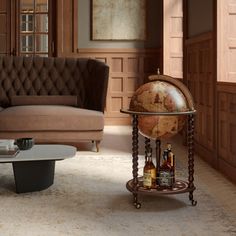 a living room filled with furniture and a globe on top of a table next to a couch