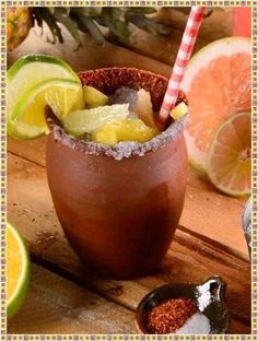 an image of a drink in a glass with ice and lemons on the side