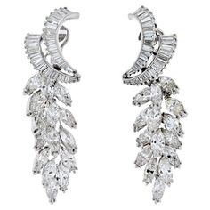 Inspired by elegance, these gorgeous scatter drop earrings frame your face with the sparkle of breathtaking baguettes and shimmering marquise-shape diamonds. It is 5cm long and is designed for pierced ears. Total Carat Weight: 21.00cttw Diamond Quality: F-G color, VS-SI clarity. Let your style shine through with these dazzling and delightful daisy-inspired diamond drop earrings. Earring Frame, Marquise Shape Diamond, Platinum Earrings, Cut Earrings, Diamond Birthstone, Design Earrings, Platinum Metal, Diamond Drop Earrings, Diamond Design