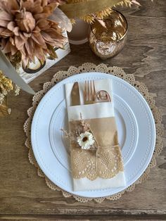 the place setting is ready to be served at this wedding reception with lace napkins and gold cutlery