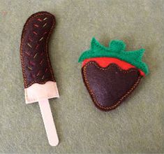 two pieces of cloth with some type of strawberry on them, one is brown and the other is green