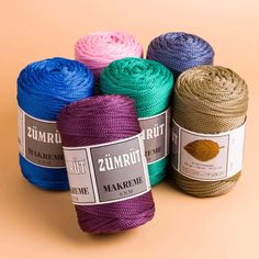 four different colors of yarn on a beige background with the words zumritt