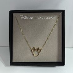 the disney x baublebar necklace in its box