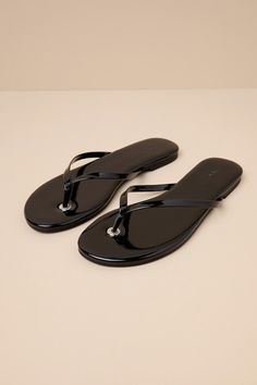 The D'Amelio Footwear BeachBae Black Patent Flat Thong Sandals are a luxe version of a wardrobe classic that every stylish cutie needs! Sleek faux patent leather shapes these must-have summer sandals that feature a slide-on silhouette with an almond-shaped footbed and two slender straps that create a timeless thong upper (with a branded grommet at the base). From micro skirts to denim shorts, these sandals will look perfect with any sunshine-inspired 'fit. 0. 25" rubber heel. Lightly cushioned s Classic Open Toe Flip Flops For Summer, Elegant Adjustable Flip Flops For Summer, Classic Flat Flip Flops For The Beach, Chic Adjustable Flat Jelly Sandals, Sleek Flip Flops With Single Toe Strap For Beach, Classic Flip Flops For Spring Beach Season, Classic Beach Flip Flops For Summer, Classic Flip Flops For Beach In Spring, Classic Flip Flops For Spring Vacation