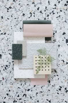 an arrangement of different materials on a white surface with black and grey speckles