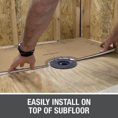 a man installing insulation on top of a floor in a home under construction with the words, easily install on top of subflor