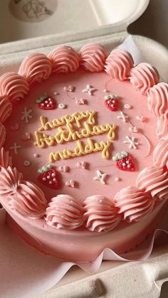 a pink birthday cake with the words happy birthday written on it