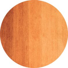 a round wooden table top with an orange stain on the surface, isolated against a white background