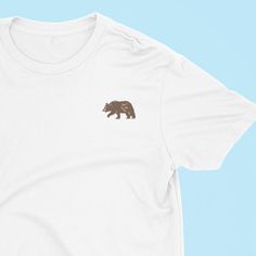 Brown Bear Tshirt Soft 100% Organic Cotton. Unisex Fit. T-SHIRT INFO The t-shirt is Stanley/Stella Organic 100% Cotton. We use sustainable fabric and fair trade certified. Sweatshop free and WRAP certified. T-shirt is embroidered to order. We donate money to animal charities. SIZING 🌼🌼 UK Sizes 🌼 X-Small approx Size 6-8 Small approx Size 8-10 Medium  approx Size 12-14 Large  approx Size 16 X Large  approx Size 18 2XL approx Size 18-20 3XL approx 20-22 4XL approx 24 5XL approx 26 Short Sleeve Tops With Graphic Embroidery For Everyday, Short Sleeve Tops With Embroidered Graphics For Everyday, Embroidered Graphic Tee, Casual Embroidered Organic Cotton Tops, White Short Sleeve Shirt With Embroidered Text, Embroidered Short Sleeve Graphic Tee, Basic Short Sleeve T-shirt With Embroidered Graphics, Basic Embroidered Short Sleeve T-shirt, Organic Cotton Crew Neck Top With Embroidered Graphics