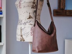 Gorgeous, slouchy brown leather crossbody bag, perfect for use as an elegant everyday bag. Adjustable strap means it can be worn across the body if preferred. Made with a quality nubuck cow hide, featuring a slightly worn-in look. The leather is durable but soft with a slightly waxy top-coat preserving the original texture and marks/scars in the animals skin. Unlined i.e. natural suede lining, and YKK zipper closure. Sturdy brown adjustable strap and antique-look rivets. ***Dimensions**... Brown Leather Crossbody Bag, Black Leather Shoulder Bag, Hobo Purse, Cow Hide, Ykk Zipper, Animal Skin, Zipper Top, The Animals, Everyday Bag