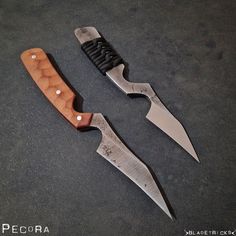 two knives are laying on the ground next to each other