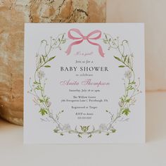 a baby shower card with a pink bow on it's head and flowers in the background