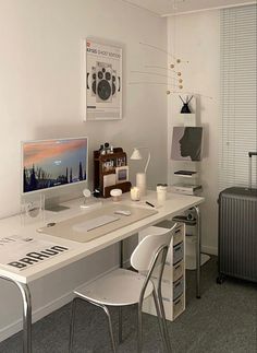 a white desk with two chairs and a computer monitor on it, next to a radiator