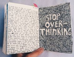 a hand holding an open book with writing on it that says stop over thinking in black ink