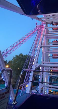 the roller coaster is lit up and ready for people to go down it at night