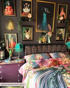 a bedroom with pictures on the wall above the bed