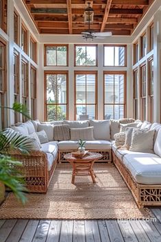 a living room filled with furniture and lots of windows