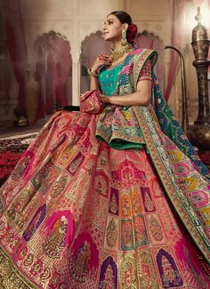 a woman in a pink and green lehenga