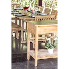 a wooden table and chairs with wine glasses on it