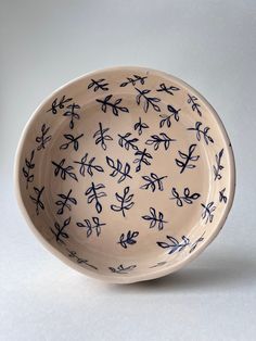 a blue and white bowl sitting on top of a table