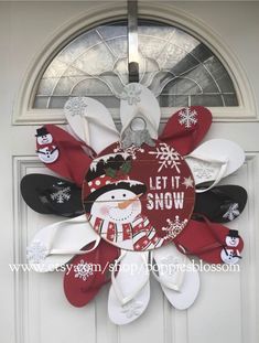 a snowman wreath with flip flops hanging from the front door