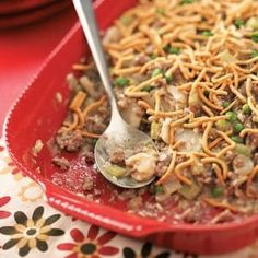 a red bowl filled with food on top of a table