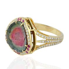 For Sale on 1stdibs - This stunning ring has been meticulously crafted from 18-karat gold. It is hand set in 9.67 carats tourmaline, .17 carats sapphire and illuminated with Luxury Tourmaline Rings, Luxury Tourmaline Emerald Ring, Luxury Tourmaline Gemstones With Accent Stones, Luxury Tourmaline Gemstones With Gemstone Accents, Luxury Multi-stone Tourmaline Ring, Luxury Multi-stone Sapphire Ring With Tourmaline, Luxury Tourmaline Jewelry With Halo Setting, Formal Multi-stone Tourmaline Sapphire Ring, Luxury Tourmaline Rings With Halo Setting