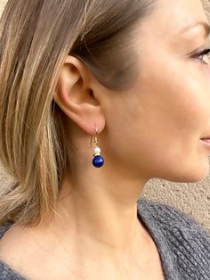 These lapis lazuli and pearl drop earrings are very elegant and versatile - amazing drop of rich blue color that will brighten up any outfit. * They are made of natural Lapis lazuli gemstones and fresh water pearls. Both are the best, AAA quality. * Lapis lazuli beads measure around 9 mm. * Drop length for these earrings 2,5 cm. * Metal - gold plated 925 silver. Earrings come in a gift box, ready to give as present. You might also like other lapis lazuli jewelry that I have: https://www.etsy.com Elegant Sapphire Earrings With Natural Stones, Blue Teardrop Pearl Drop Earrings, Elegant Blue Teardrop Pearl Earrings, Elegant Lapis Lazuli Earrings As A Gift, Blue Teardrop Pearl Earrings With Gemstone, Lapis Lazuli Teardrop Earrings As Gift, Blue Teardrop Sterling Silver Pearl Earrings, Elegant Blue Pearl Earrings With Natural Stones, Elegant Lapis Lazuli Earrings For Gift