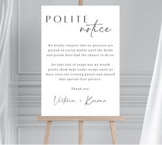 a white sign with the words polite note on it in front of curtained windows