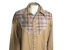 "Vintage 70's plaid cowboy shirt, tag says Sears, sz X-large, 65% polyester 35% cotton. Shirt is tan, quilted plaid detailing shoulders, snaps up with pearl buttons, shirt has stain on back- see last pic., measurements are shoulder to shoulder 18\" under arms 25\" across waist 24\" across length 29\" sleeve length 25\"" Collared Shirt For Ranch In Fall, Fitted Western Brown Shirt, Fitted Brown Western Shirt, Brown Fitted Western Shirt, Western Brown Tops With Snap Buttons, Brown Collared Western Shirt, Western Style Brown Collared Top, Western Brown Collared Tops, Brown Western Style Shirt For Fall