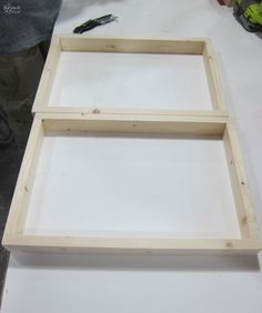 two wooden frames sitting on top of a table