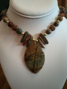 "Picasso Jasper Semi-Precious Necklace 20\" Long Picture Jasper  in dragon teeth shaped beads 23mm long x 5mm wide, 8mm beads and 10mm coin shaped beads and Pendant 2 1/2L x 1 1/2W Picture Jasper gives off intense stabilization against negative energy on the Earth and around the wearer.  It balances the yin-yang energy as well. It is \"The Stone of Global Awareness\".  It stimulates brotherhood." Semi Precious Stone Jewelry Necklace, Artisan Jasper Gemstone Necklaces, Spiritual Multicolor Jasper Necklaces, Unique Multicolor Jasper Necklaces, Nature-inspired Jasper Stone Necklaces, Unique Brown Jasper Necklace, Stone Jewelry Necklace, Semi Precious Necklace, Semiprecious Stone Jewelry