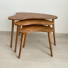 three wooden tables stacked on top of each other